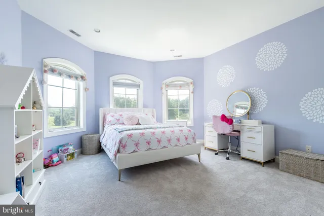 a view of swimming pool with lawn chairs and plants