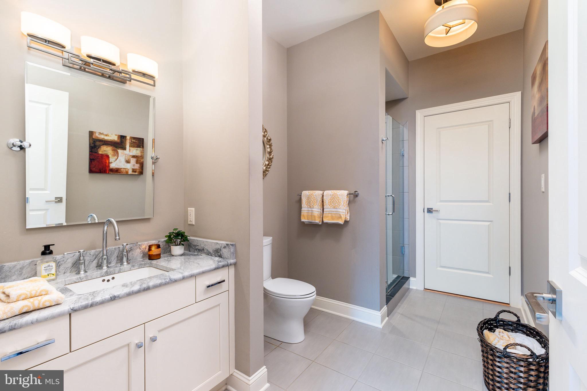 3 Stonebridge Crossing Road Newtown, PA 18940 - Photo 47 of 77 a spacious bathroom with a granite countertop sink toilet and a mirror