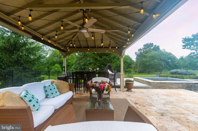 a view of a big house with a big yard plants and large trees