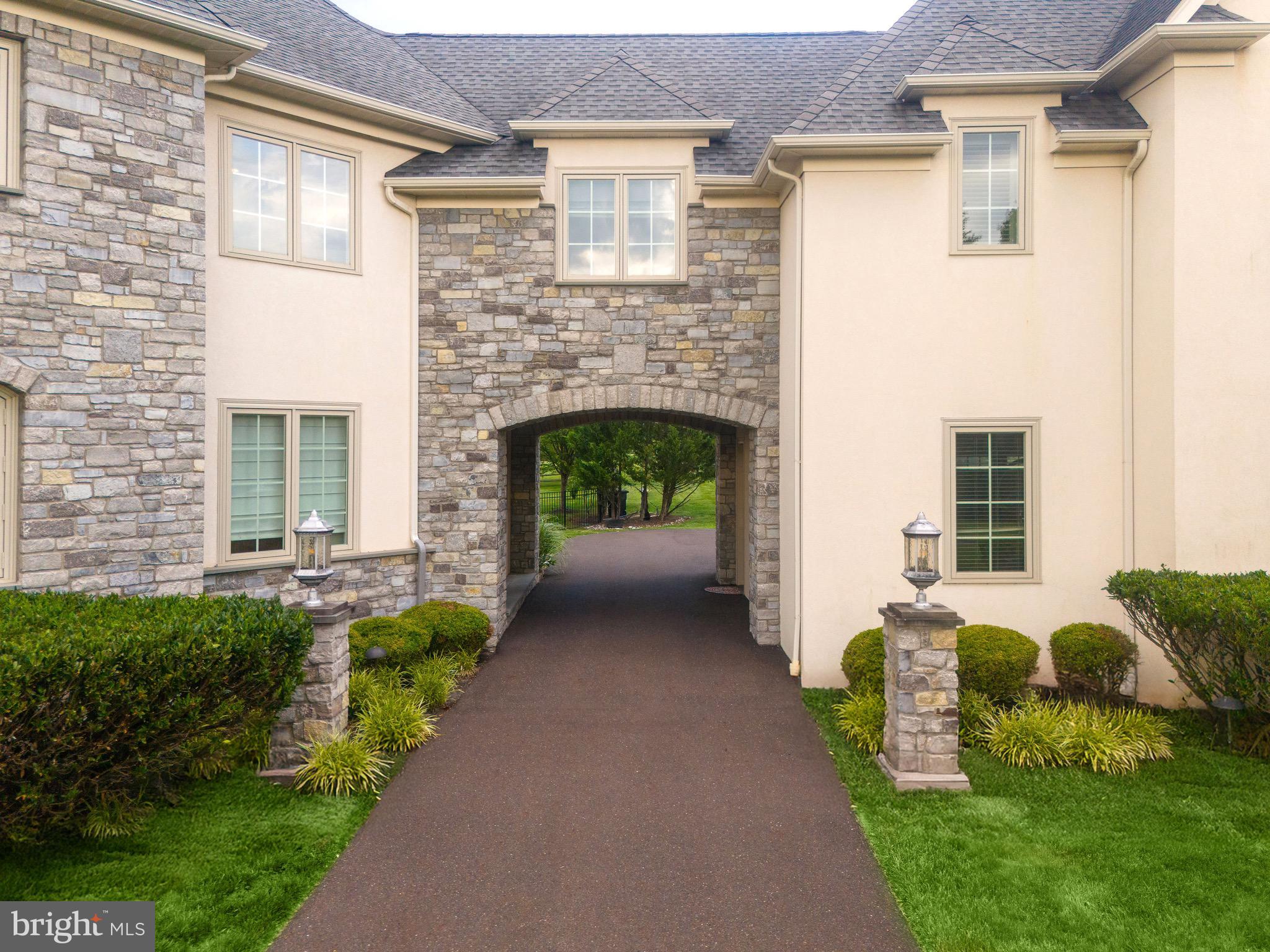3 Stonebridge Crossing Road Newtown, PA 18940 - Photo 75 of 77 a front view of a house with a garden and plants