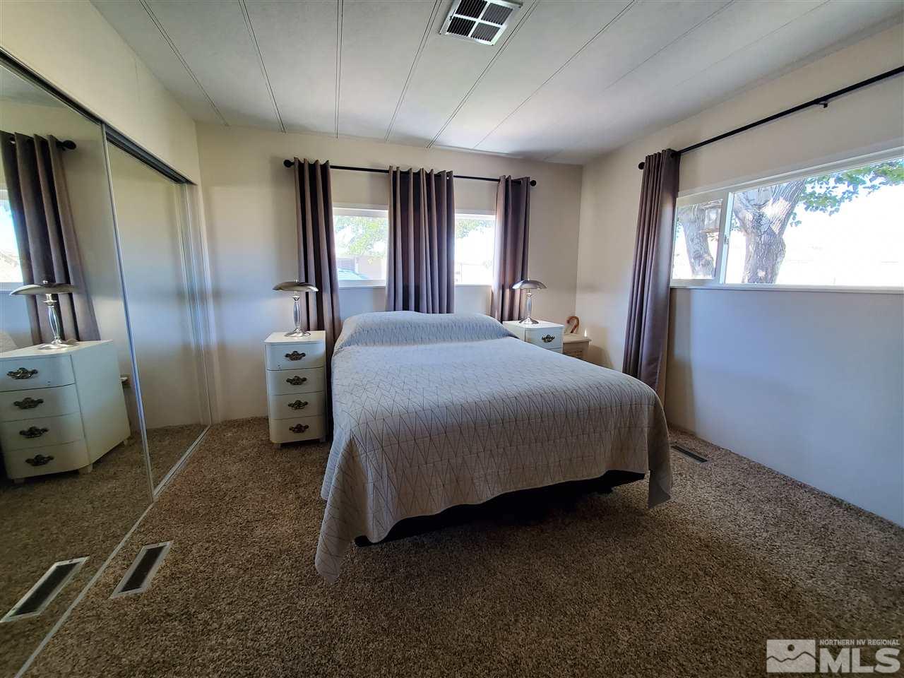 185 Aries Circle Reno, NV 89521 - Photo 11 of 18 a bedroom with a bed dresser and a window