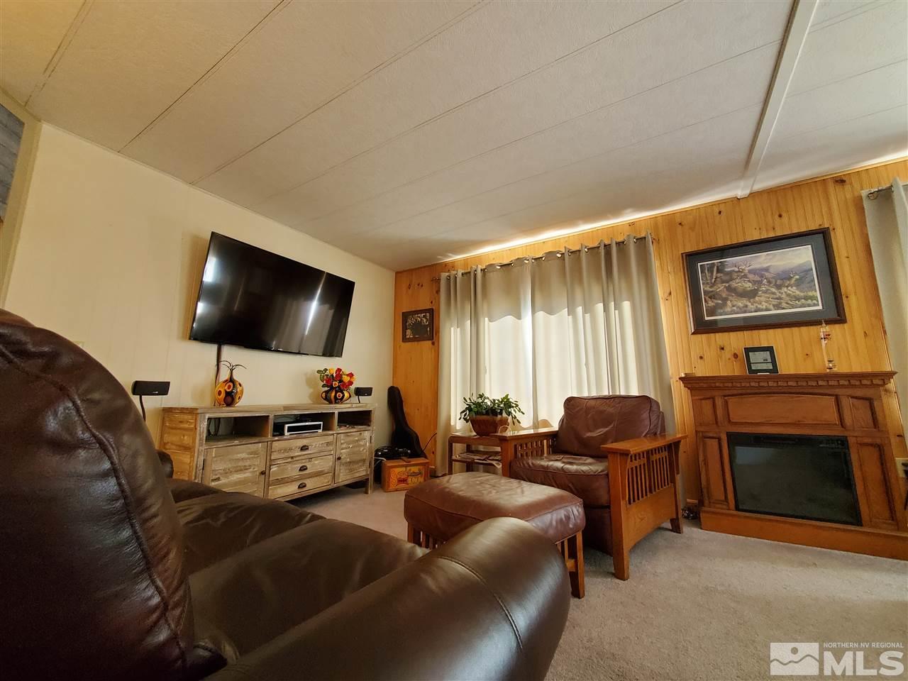 185 Aries Circle Reno, NV 89521 - Photo 3 of 18 a living room with furniture and a flat screen tv