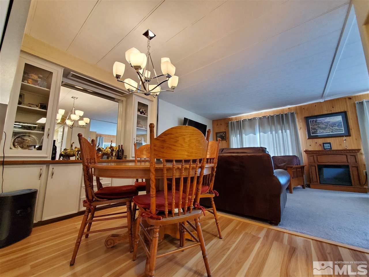 185 Aries Circle Reno, NV 89521 - Photo 4 of 18 a view of a dining room with furniture and wooden floor