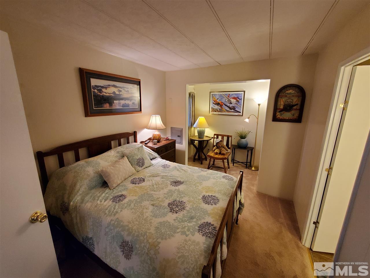 185 Aries Circle Reno, NV 89521 - Photo 9 of 18 a bed sitting in a bedroom next to a window