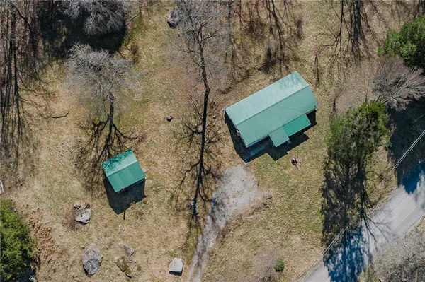 a green field with trees in the background