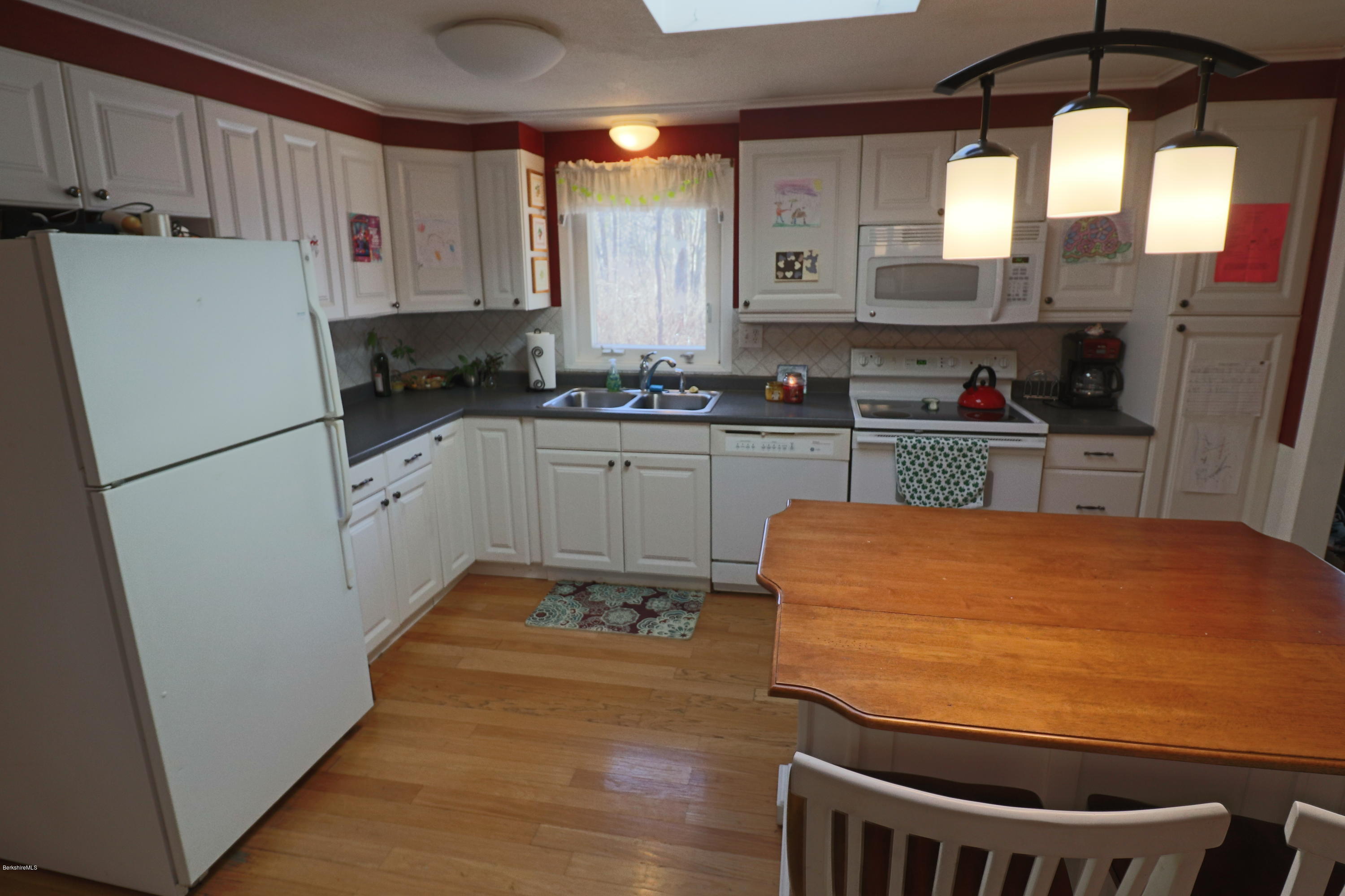 3 Mohawk Lake Road Stockbridge, MA 01229 - Photo 14 of 29 a kitchen with stainless steel appliances granite countertop a refrigerator a sink a stove and white cabinets
