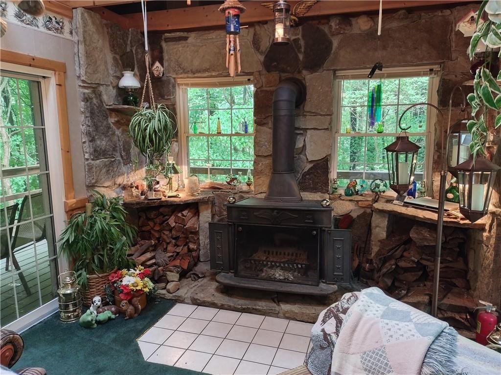 399 Long Road Utica, PA 16362 - Photo 5 of 17 a living room with furniture a window and a fireplace