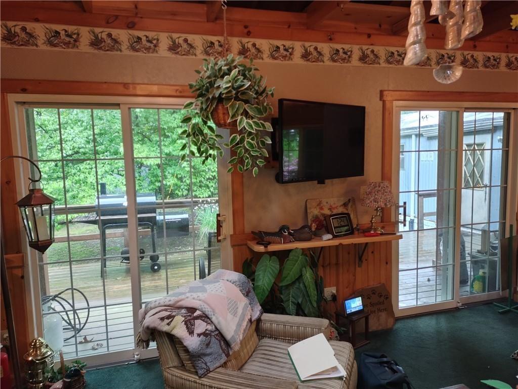 399 Long Road Utica, PA 16362 - Photo 8 of 17 a living room with furniture a flat screen tv and a floor to ceiling window