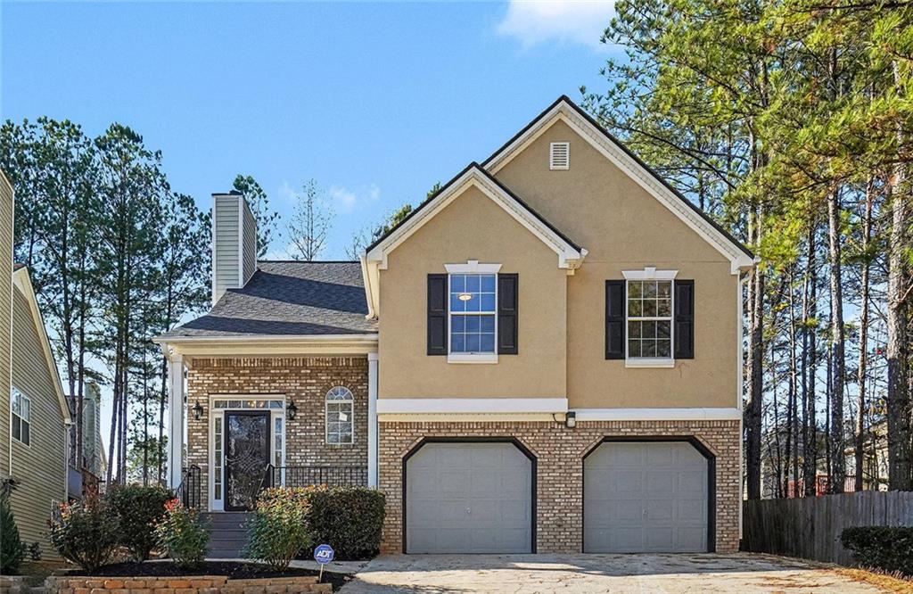 2816 Crest Ridge Way Southwest Marietta, GA 30060 - Photo 1 of 1 a front view of a house with mountain and trees