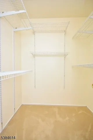 a bathroom with a toilet a sink a mirror and a window