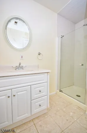 a bathroom with a sink mirror and a shower