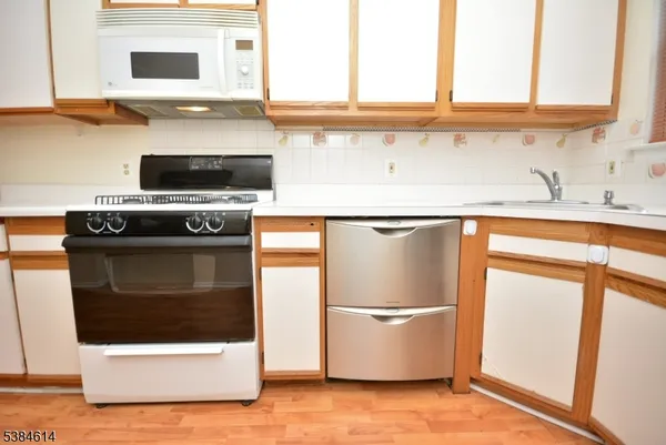 a kitchen with stainless steel appliances a refrigerator sink and cabinets