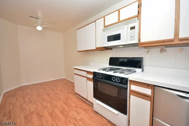 a kitchen with cabinets and appliances