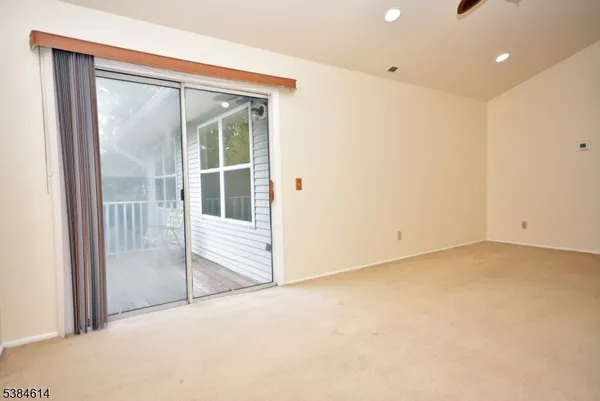 a view of an empty room with a sliding door