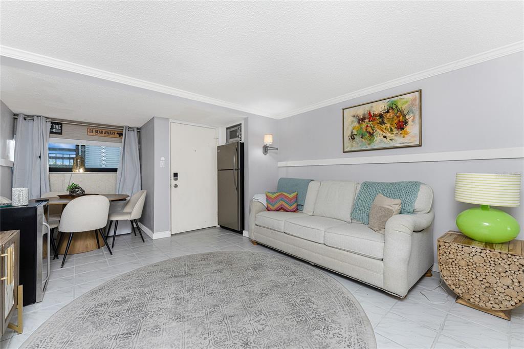 1401 Beach Road, Unit 303 Englewood, FL 34223 - Photo 36 of 63 a living room with furniture and a painting on the wall