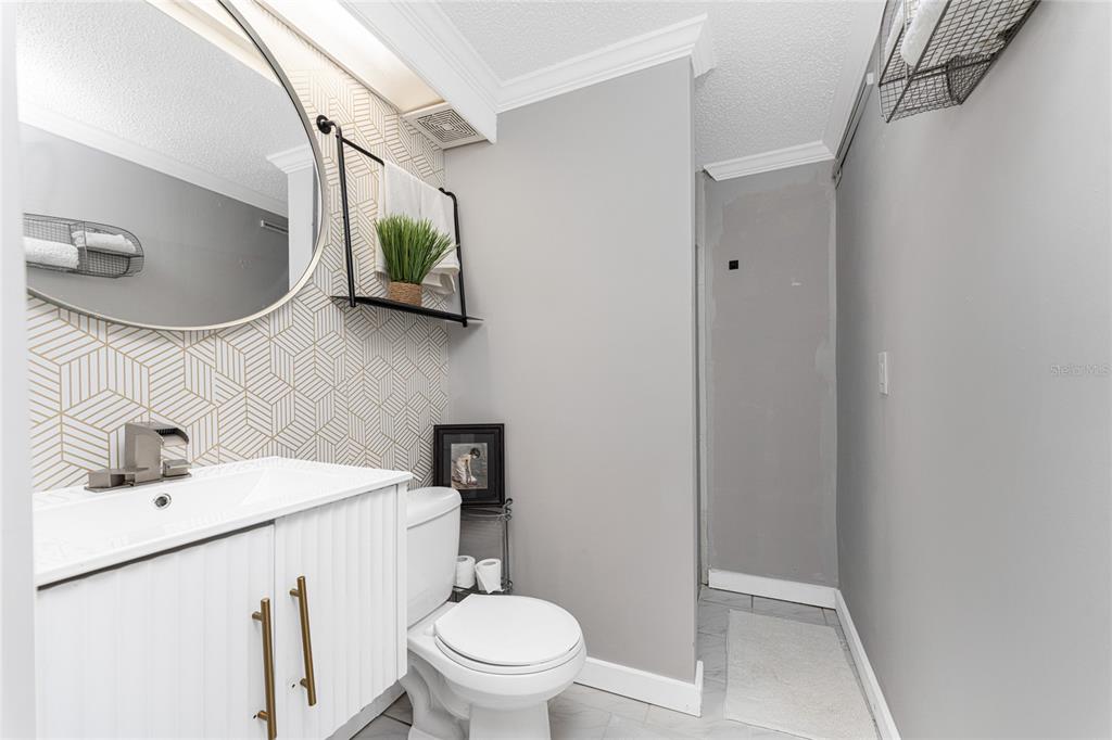 1401 Beach Road, Unit 303 Englewood, FL 34223 - Photo 40 of 63 a bathroom with a toilet sink and mirror