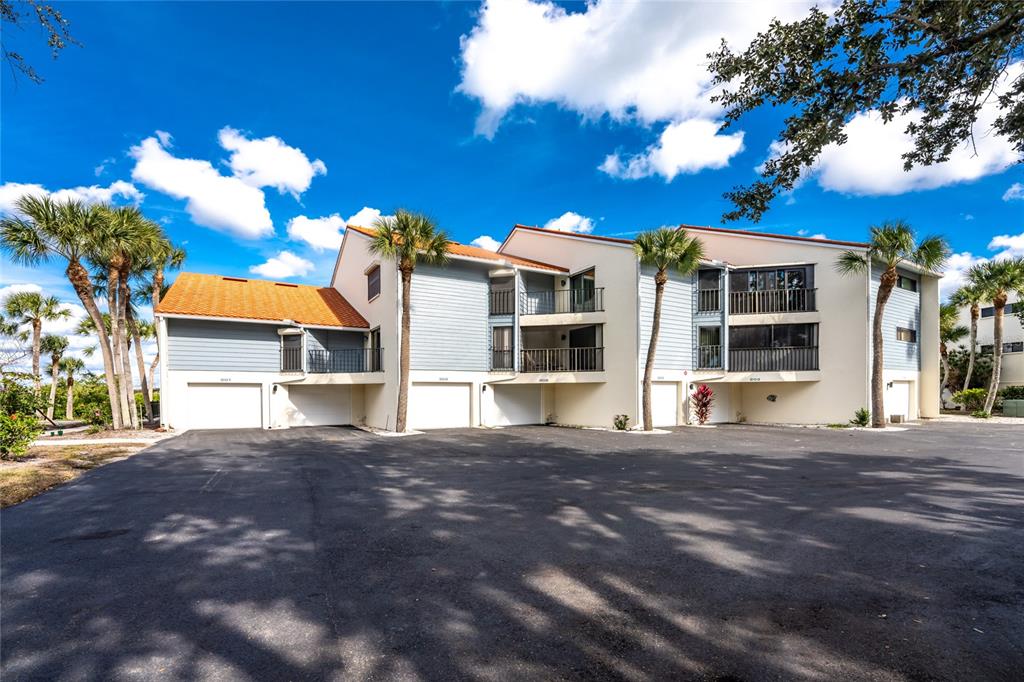 1401 Beach Road, Unit 303 Englewood, FL 34223 - Photo 47 of 63 a front view of a house with a yard