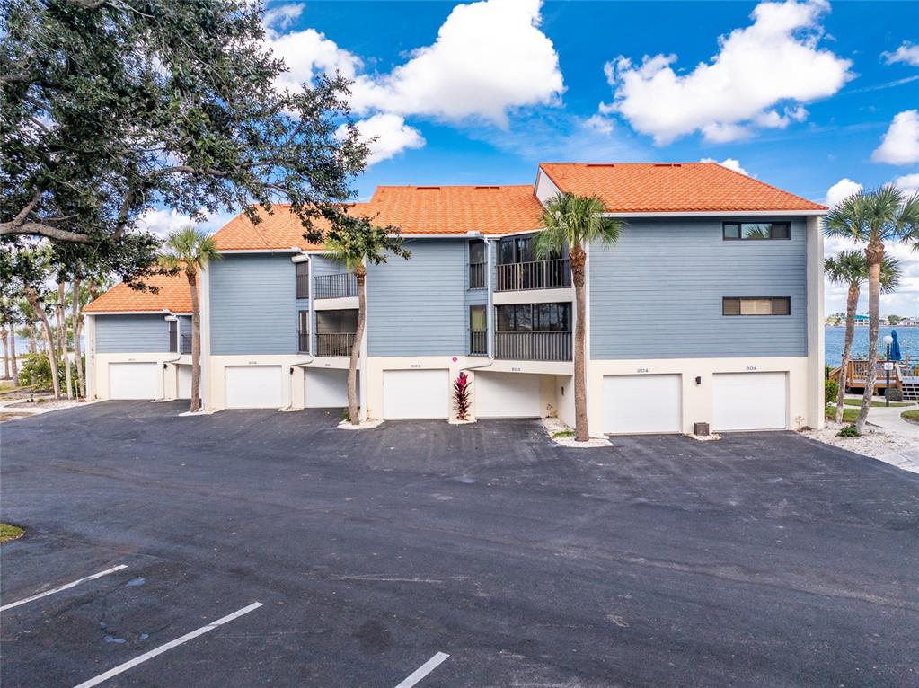 1401 Beach Road, Unit 303 Englewood, FL 34223 - Photo 48 of 63 a view of a house with backyard and a tree