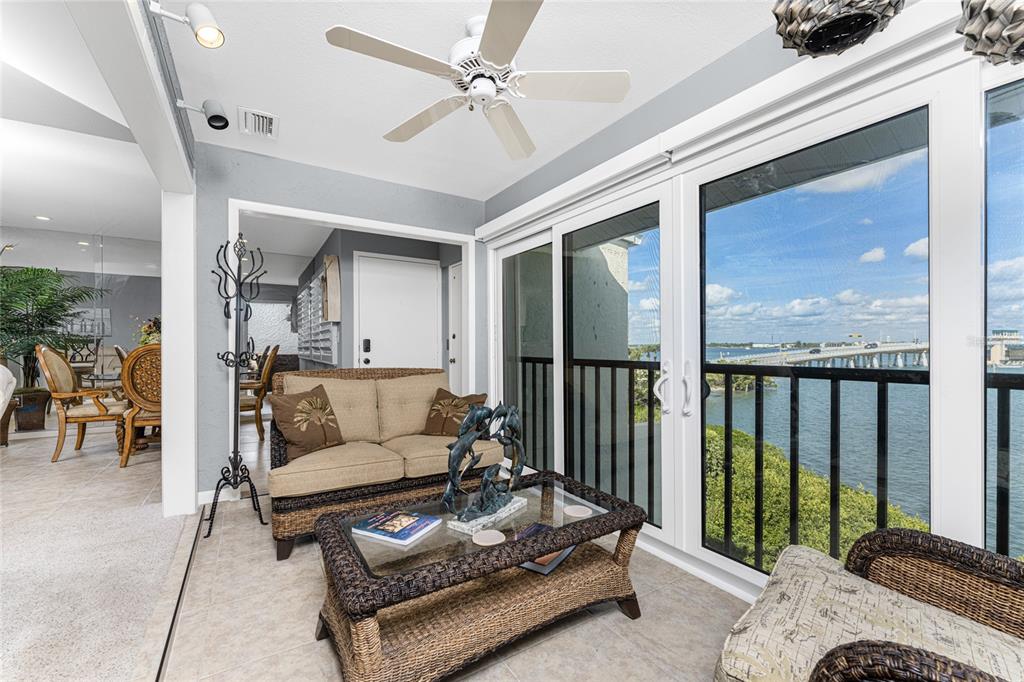 1401 Beach Road, Unit 303 Englewood, FL 34223 - Photo 9 of 63 a living room with furniture and a floor to ceiling window