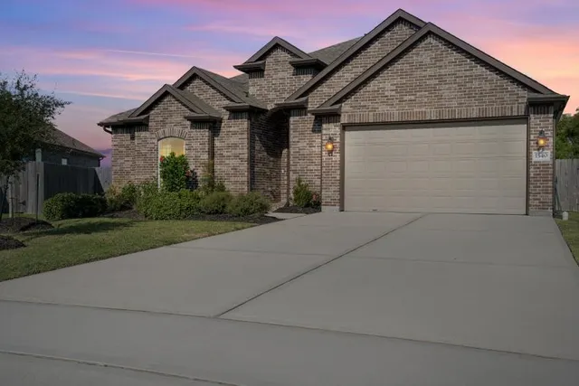 a front view of a house with yard and garage