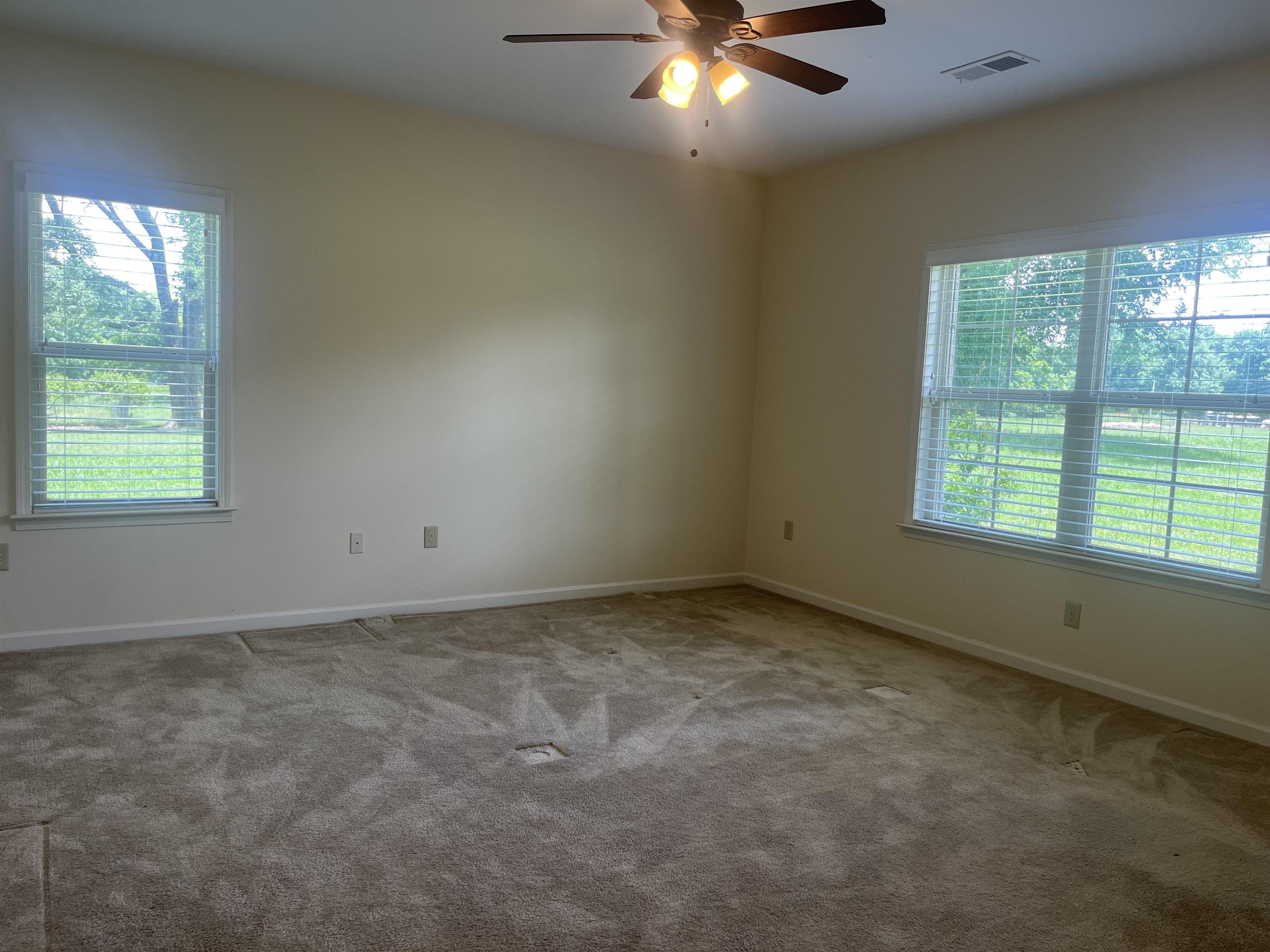 185 Belmont Road Mason, TN 38049 - Photo 17 of 40 Carpeted interior room with multiple windows and a ceiling fan