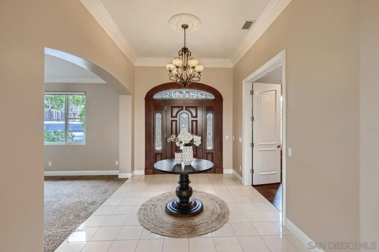 3965 Packard Lane Carlsbad, CA 92008 - Photo 12 of 32 a living room with fireplace furniture and a chandelier