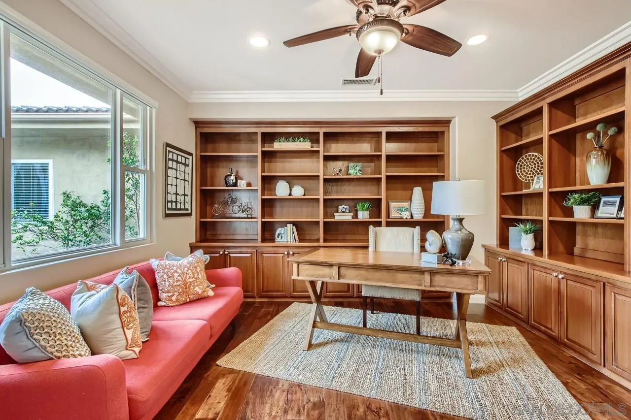3965 Packard Lane Carlsbad, CA 92008 - Photo 13 of 32 a living room with furniture and a book shelf