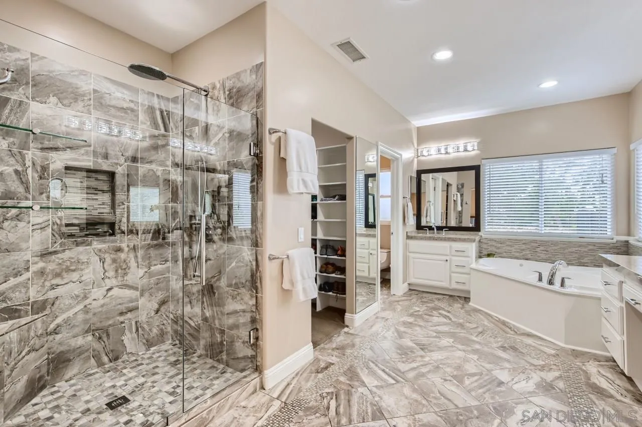 3965 Packard Lane Carlsbad, CA 92008 - Photo 17 of 32 a bathroom with a bathtub and a shower
