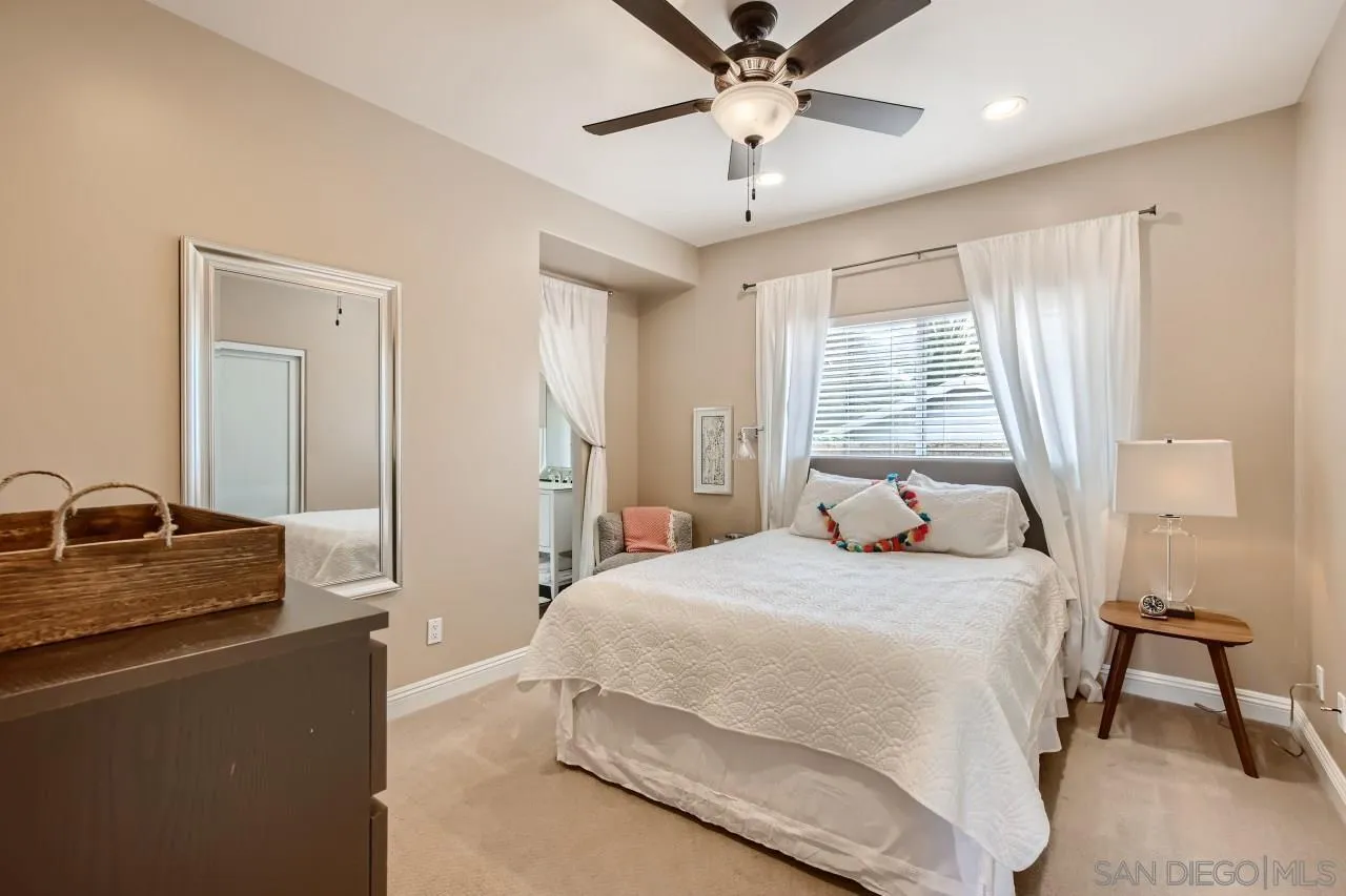 3965 Packard Lane Carlsbad, CA 92008 - Photo 23 of 32 a bedroom with a large bed and a chandelier