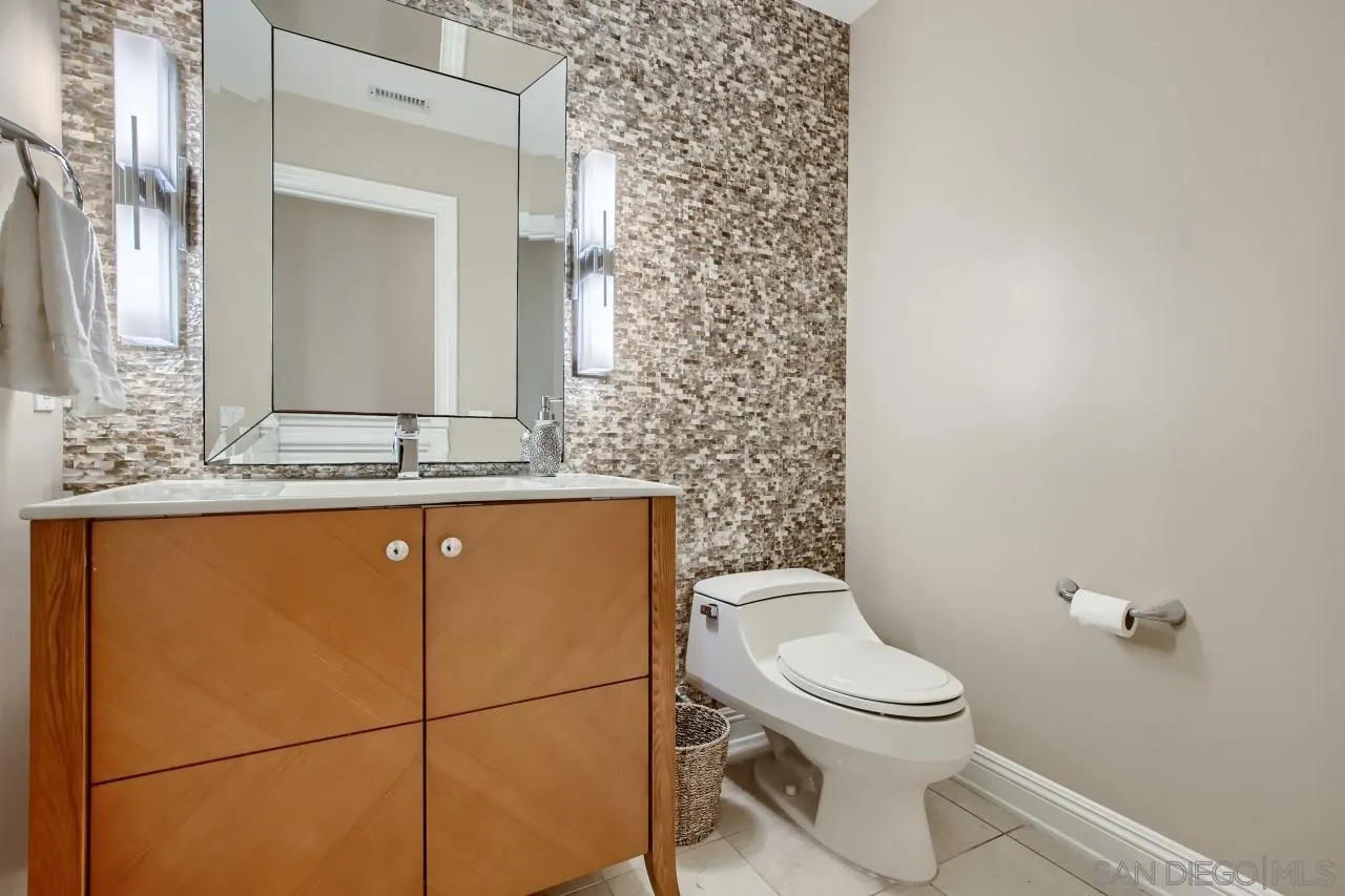 3965 Packard Lane Carlsbad, CA 92008 - Photo 26 of 32 a bathroom with a granite countertop toilet and a sink