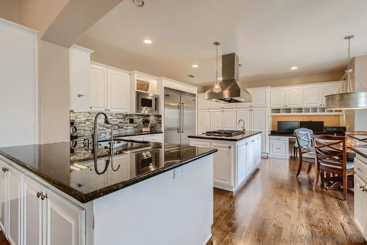 3965 Packard Lane Carlsbad, CA 92008 - Photo 3 of 32 a kitchen with stainless steel appliances granite countertop a sink a stove and a refrigerator
