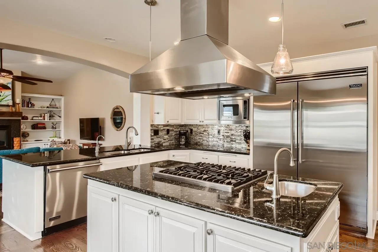 3965 Packard Lane Carlsbad, CA 92008 - Photo 4 of 32 a kitchen with granite countertop a sink stainless steel appliances and cabinets
