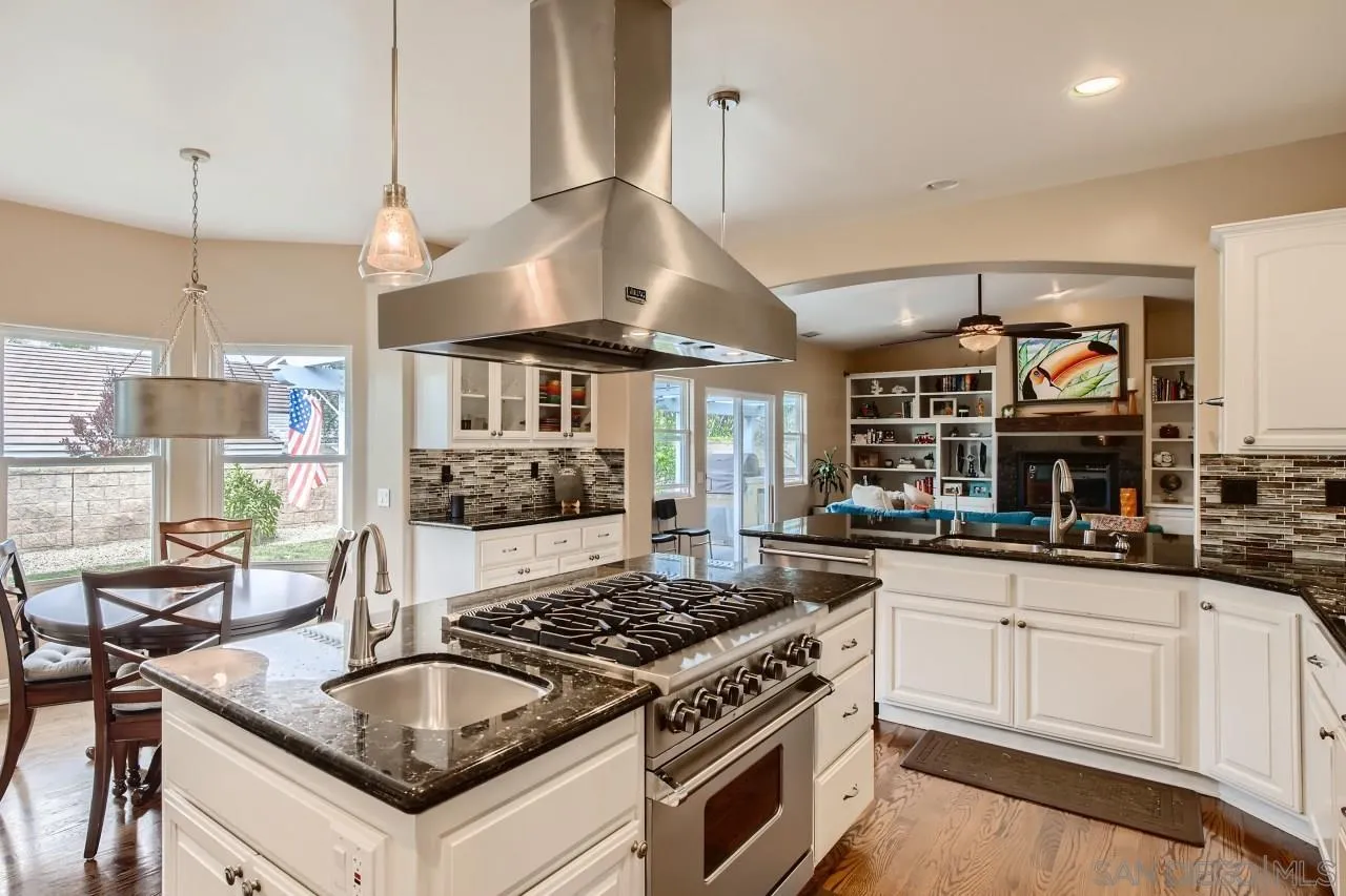 3965 Packard Lane Carlsbad, CA 92008 - Photo 5 of 32 a kitchen with stainless steel appliances granite countertop a stove and a sink