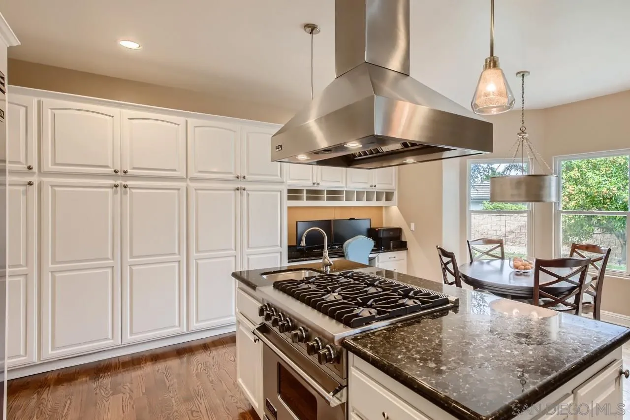 3965 Packard Lane Carlsbad, CA 92008 - Photo 6 of 32 a kitchen with stove and a table