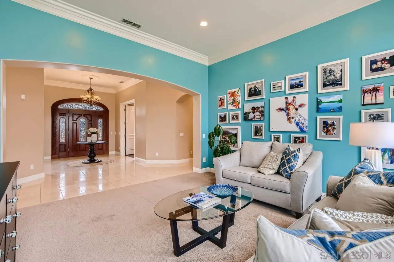 3965 Packard Lane Carlsbad, CA 92008 - Photo 9 of 32 a living room with furniture and a book shelf