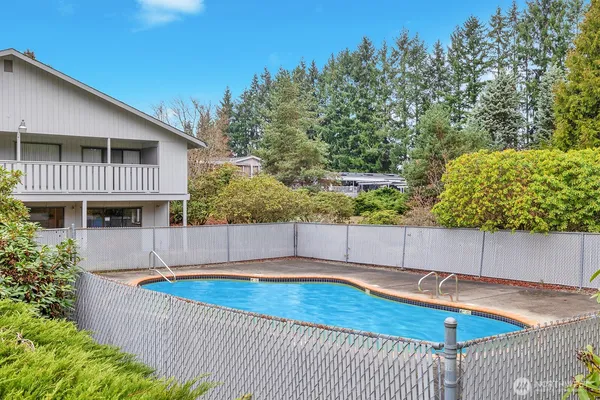 a view of a house with a backyard and trees