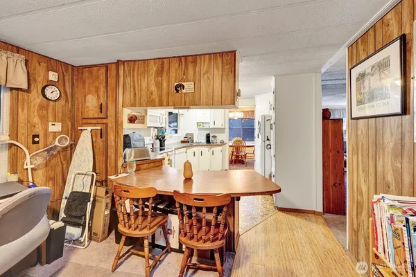 a dining room with furniture and wooden floor