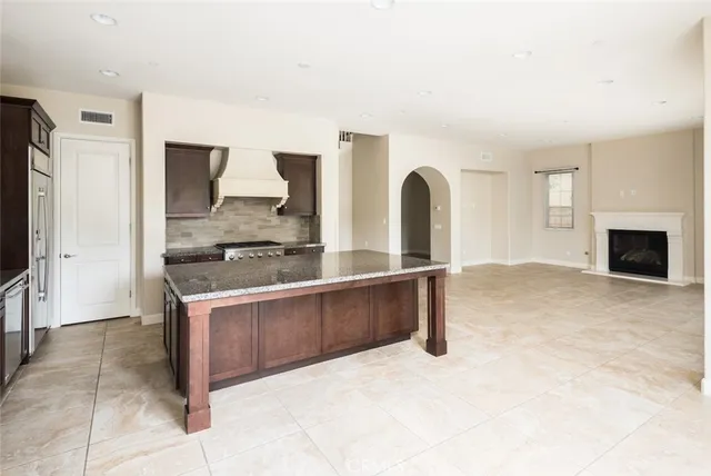 a kitchen with granite countertop a sink and a counter top space