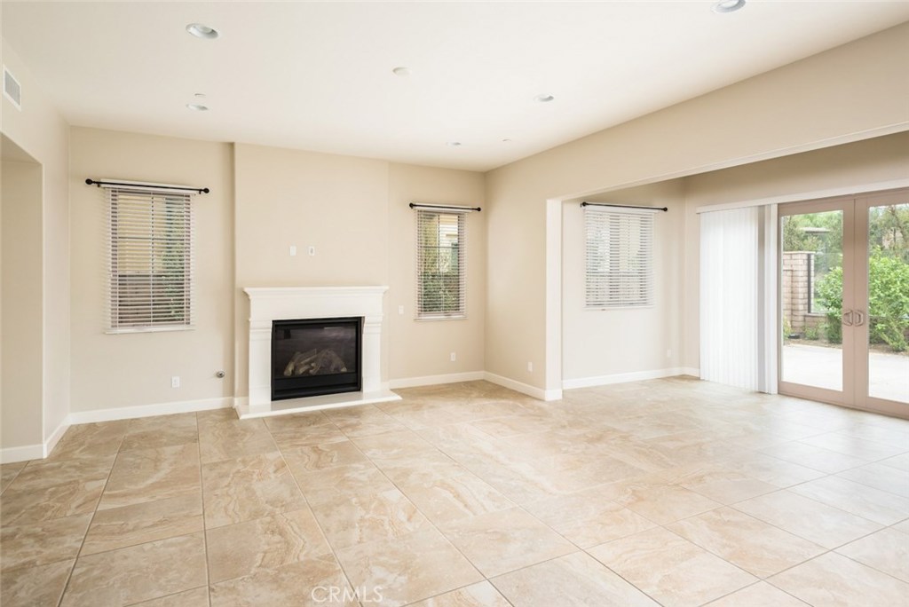 136 Long Fence Irvine, CA 92602 - Photo 13 of 26 an empty room with windows and fireplace