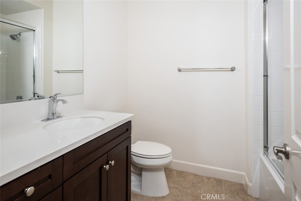 136 Long Fence Irvine, CA 92602 - Photo 22 of 26 a bathroom with a sink a toilet and a mirror