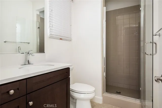 a large kitchen with stainless steel appliances a stove a refrigerator and a sink