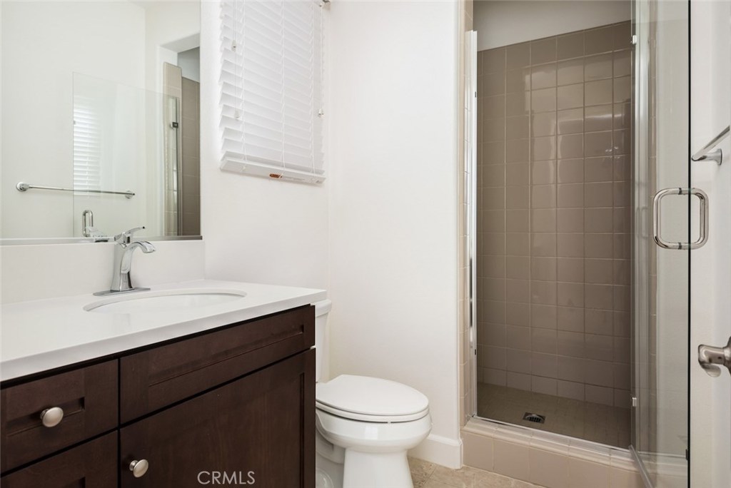 136 Long Fence Irvine, CA 92602 - Photo 25 of 26 a bathroom with a sink toilet and shower