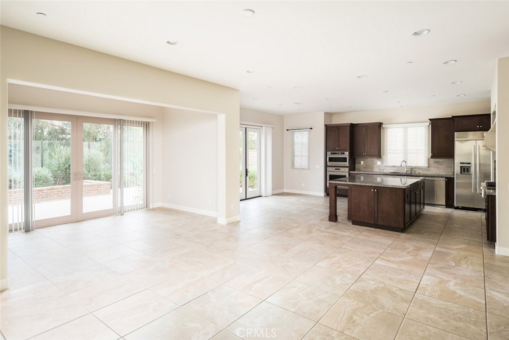 136 Long Fence Irvine, CA 92602 - Photo 26 of 26 a large kitchen with stainless steel appliances a stove a refrigerator and a sink