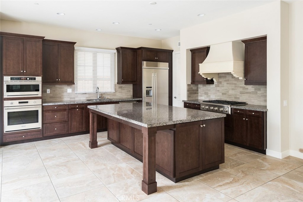 136 Long Fence Irvine, CA 92602 - Photo 7 of 26 a kitchen with stainless steel appliances granite countertop a stove a sink and a refrigerator