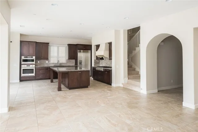 a kitchen with granite countertop a sink and cabinets