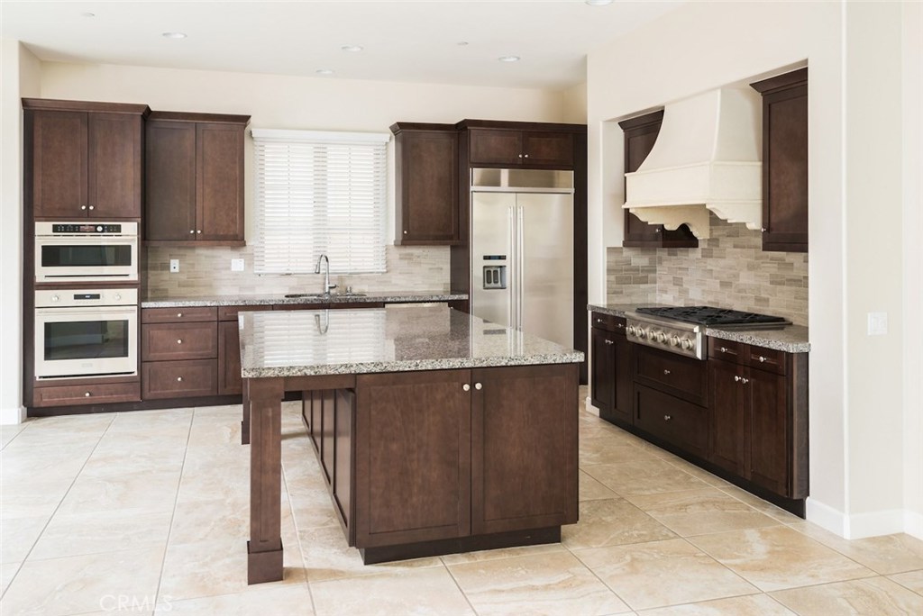 136 Long Fence Irvine, CA 92602 - Photo 9 of 26 a kitchen with granite countertop a sink and cabinets