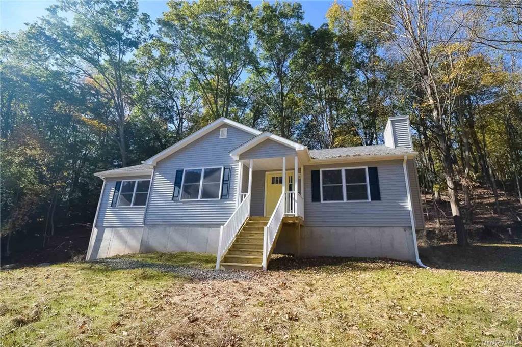 a house that has a tree in front of it