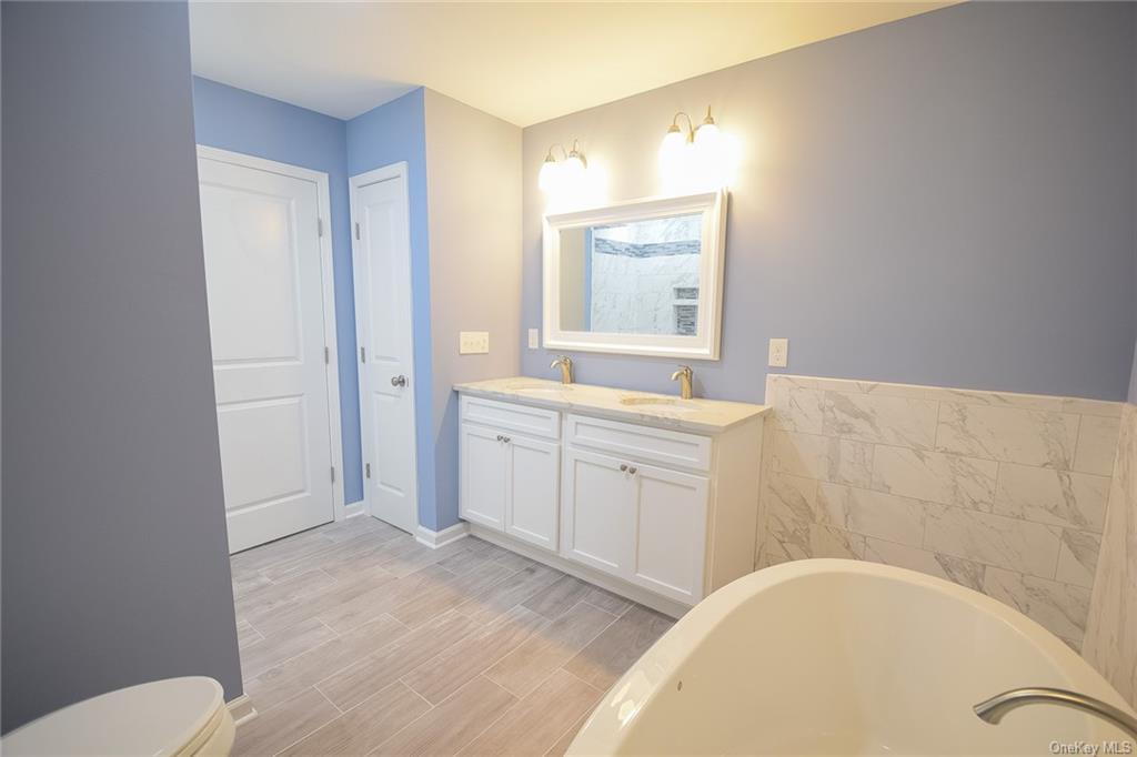 Lot #2 Old Forestburgh Road Sparrowbush, NY 12780 - Photo 15 of 17 a bathroom with a bathtub sink mirror and vanity