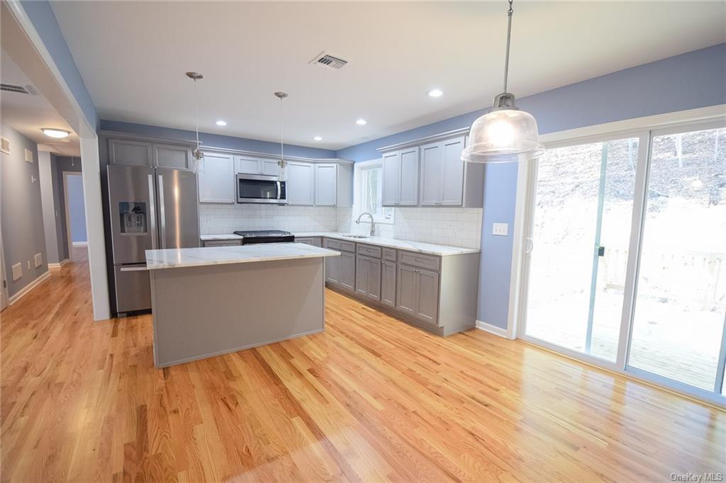 Lot #2 Old Forestburgh Road Sparrowbush, NY 12780 - Photo 4 of 17 a large kitchen with stainless steel appliances granite countertop a stove a sink dishwasher and a refrigerator with wooden floor