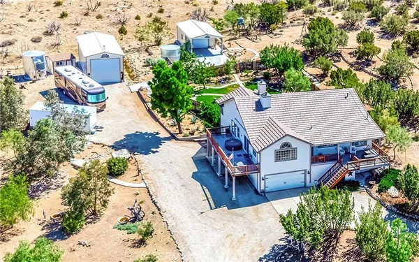 an aerial view of a house with swimming pool and garden